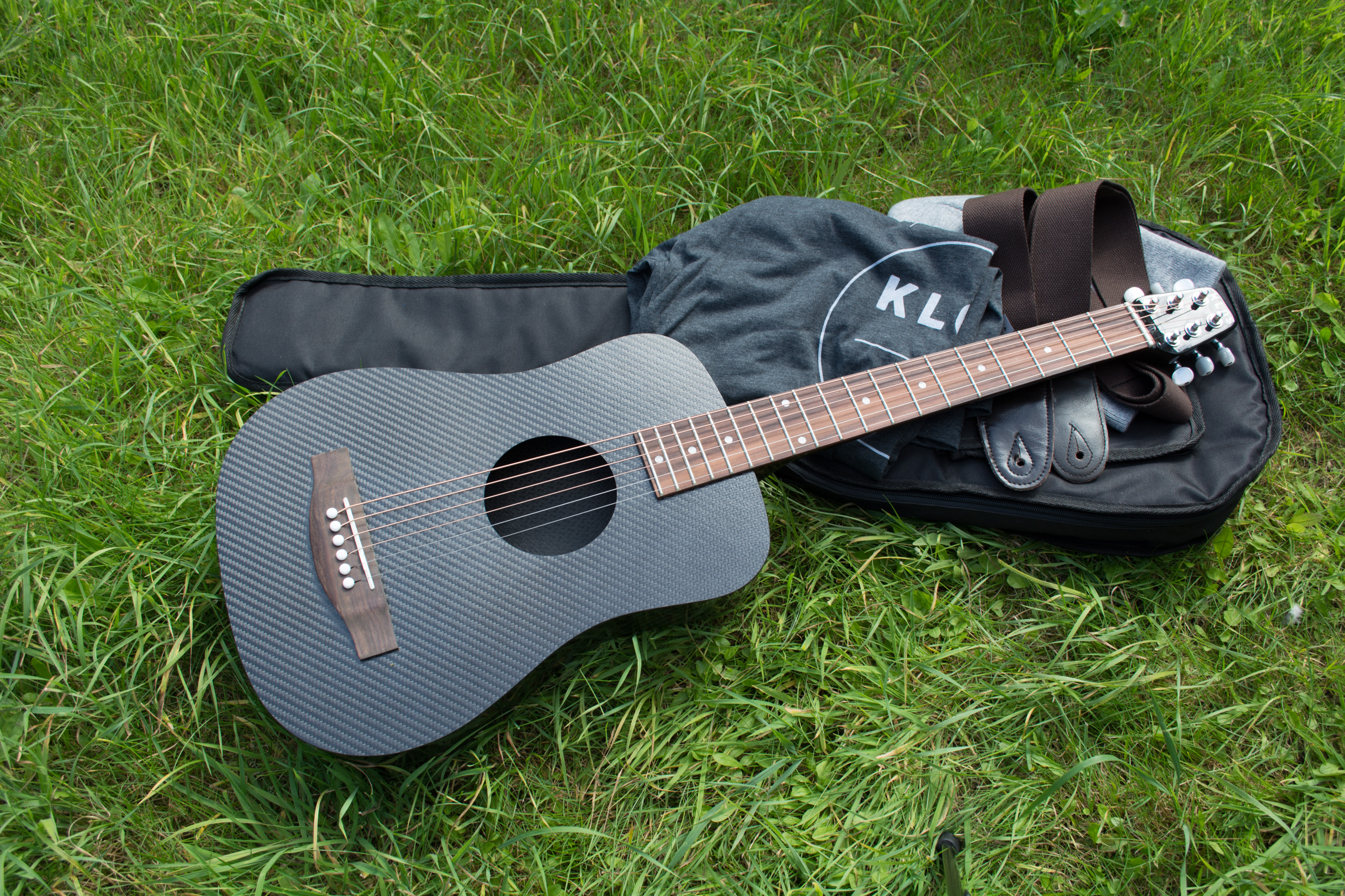 KLŌS 2.0 Carbon Fiber Travel Guitar Bundle on Grass
